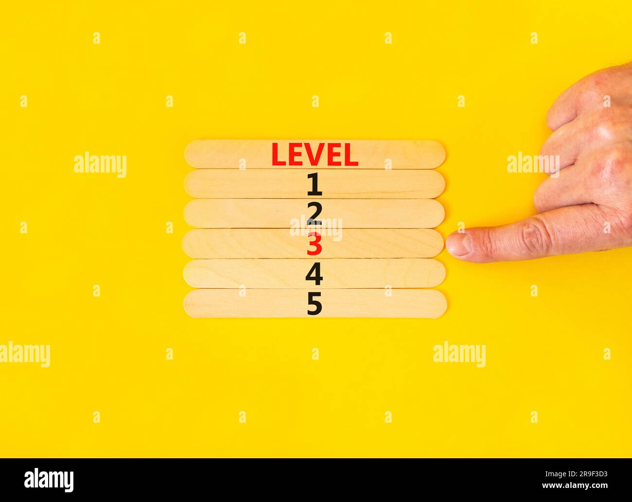 Time to level 3 symbol. Concept word Level 1 2 3 4 5 on wooden sticks ...