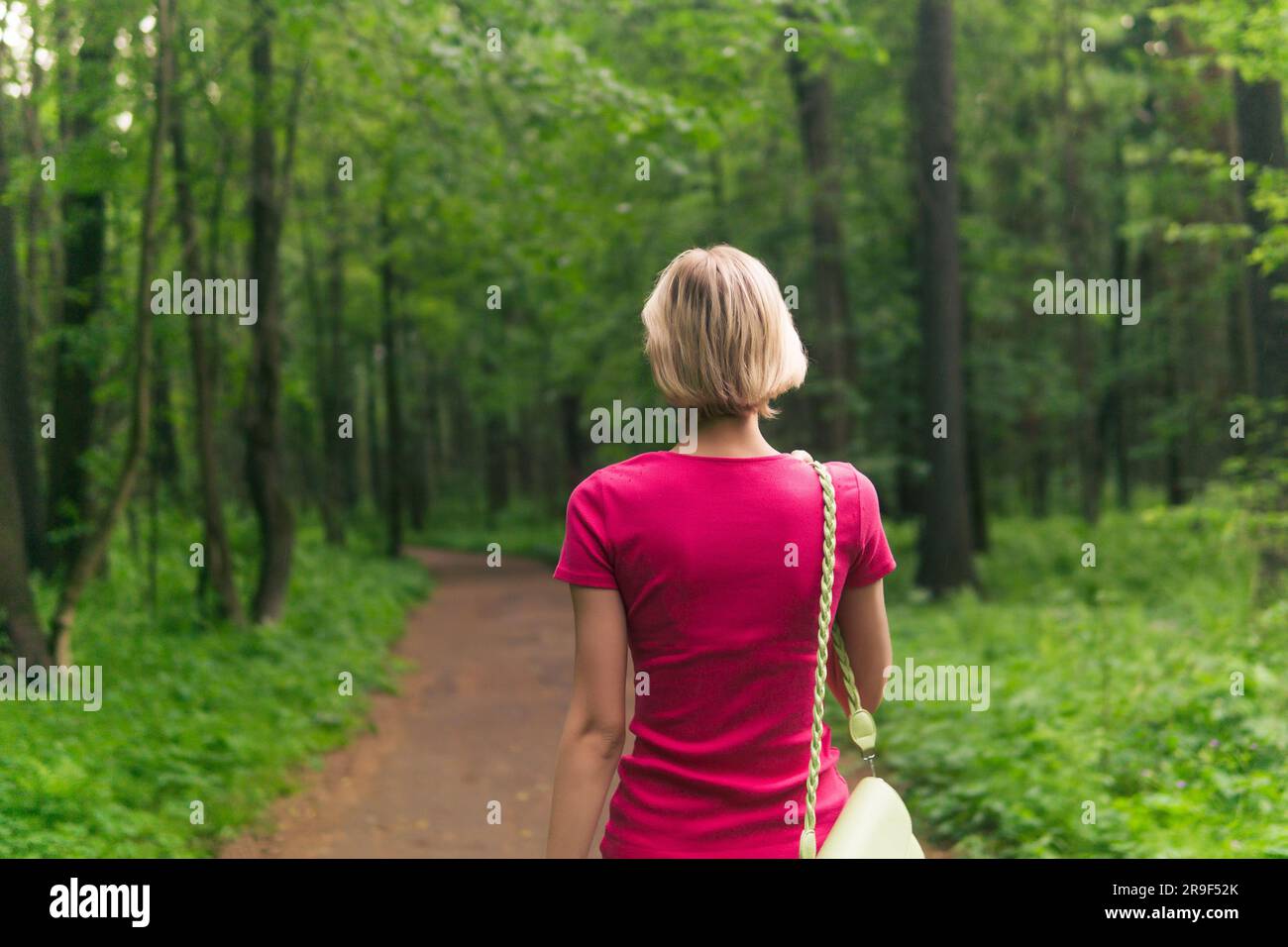 Girl walking alone through park hi-res stock photography and images - Alamy