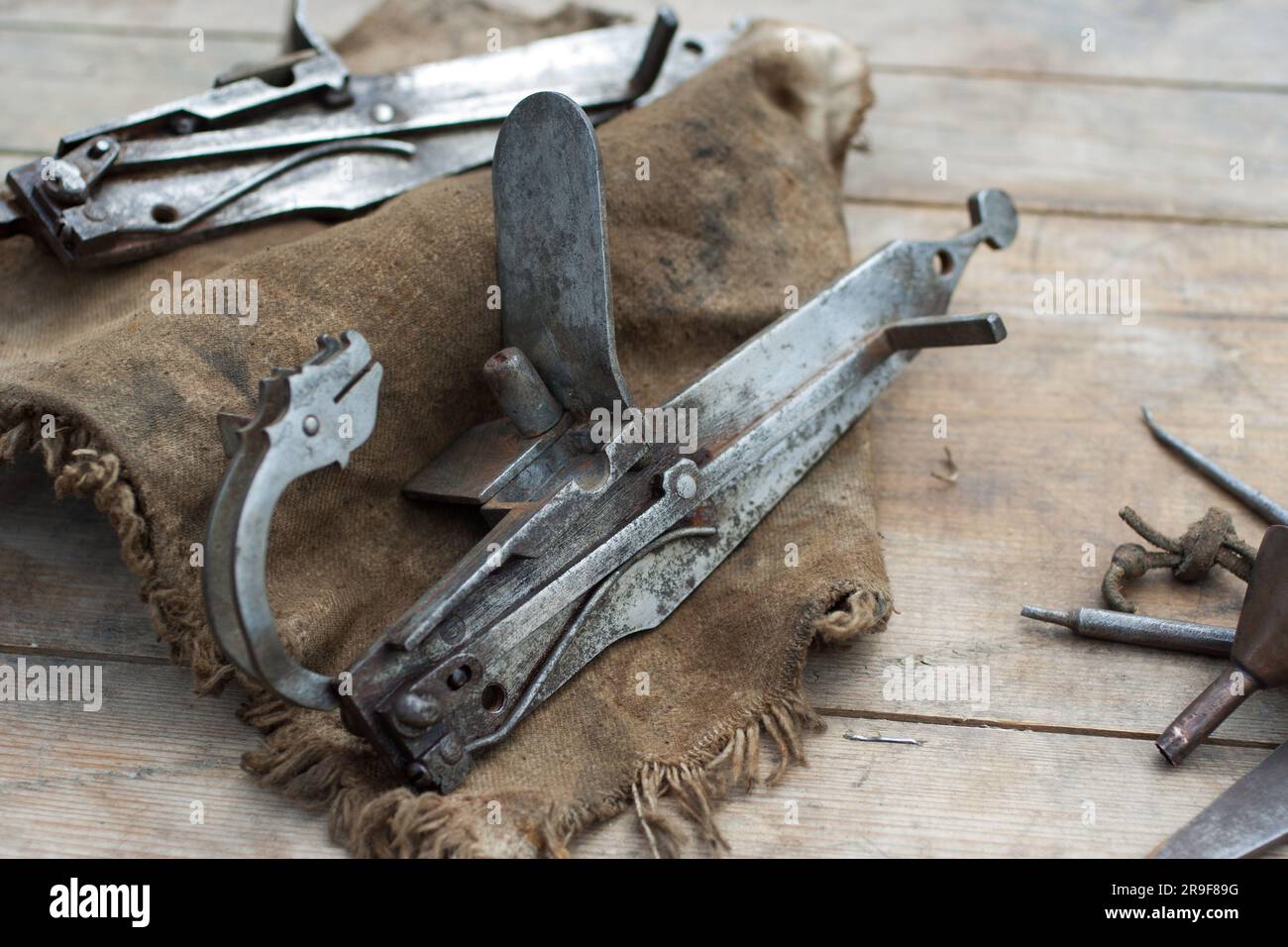 17th century ancient matchlock for musket on wooden deck. Stock Photo