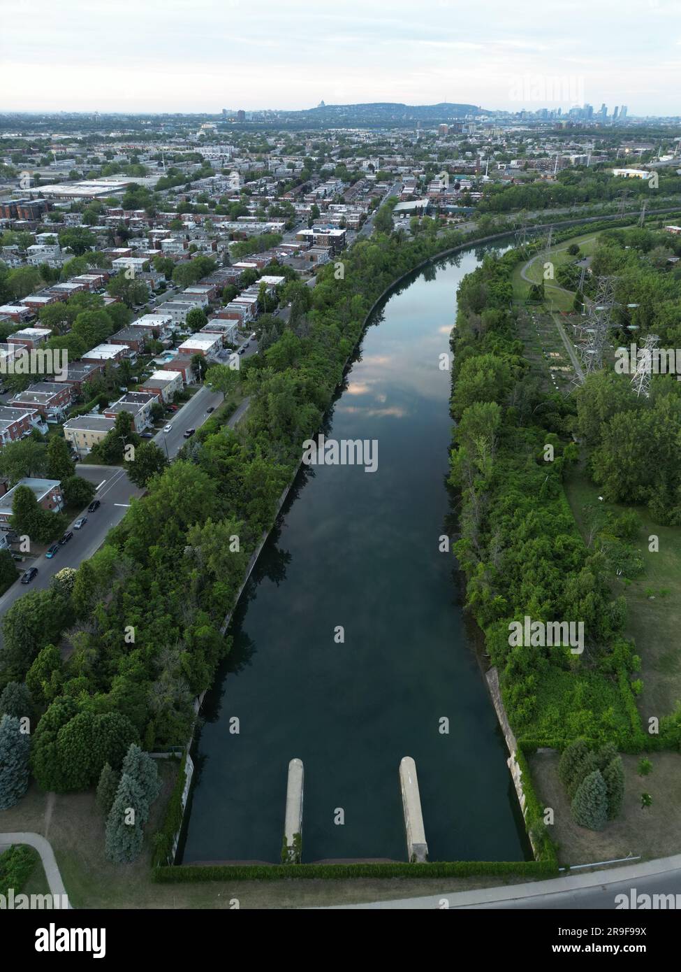 An aerial view of a river surrounded by greenery in a town in the ...