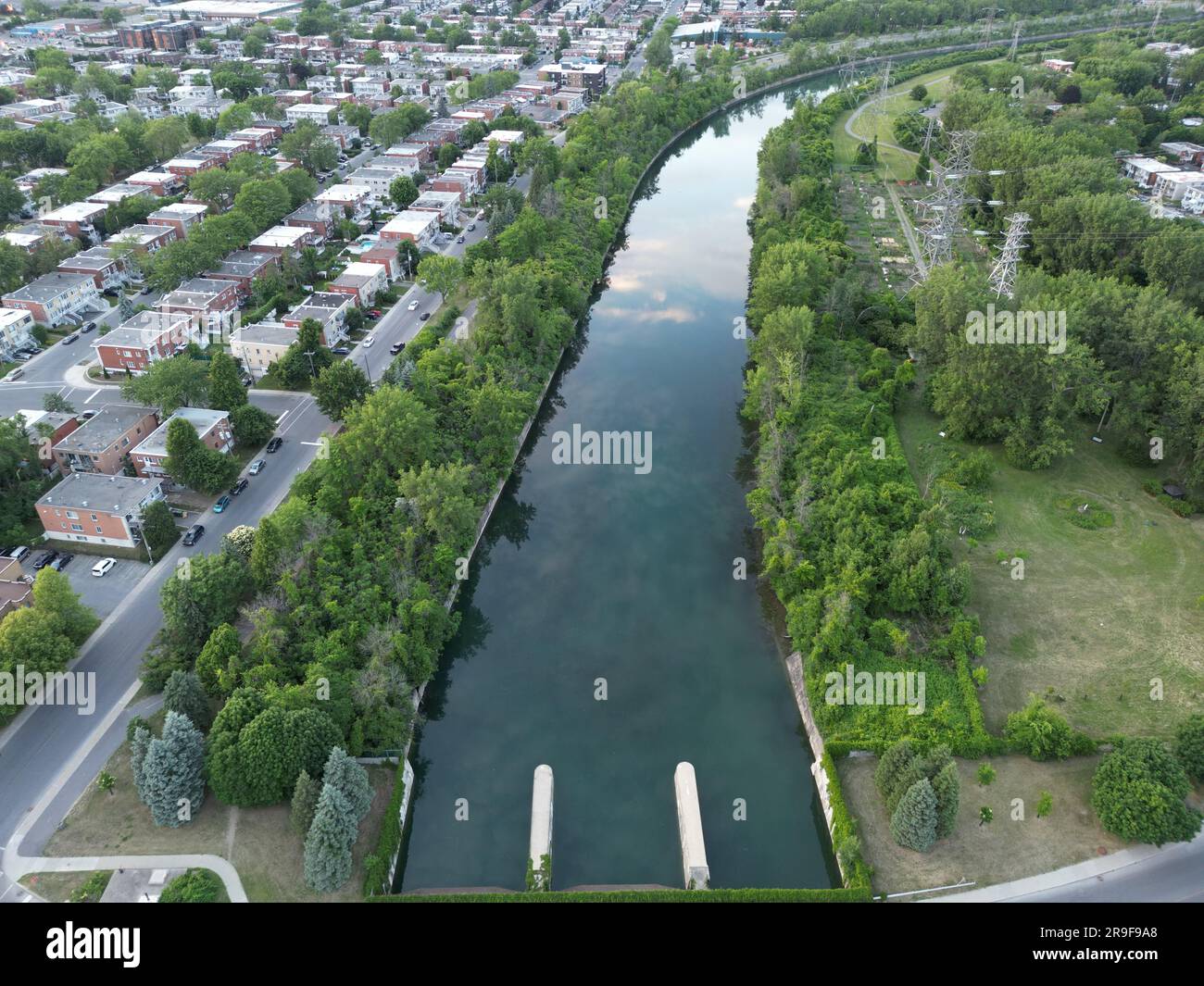 An aerial view of a river surrounded by greenery in a town in the ...