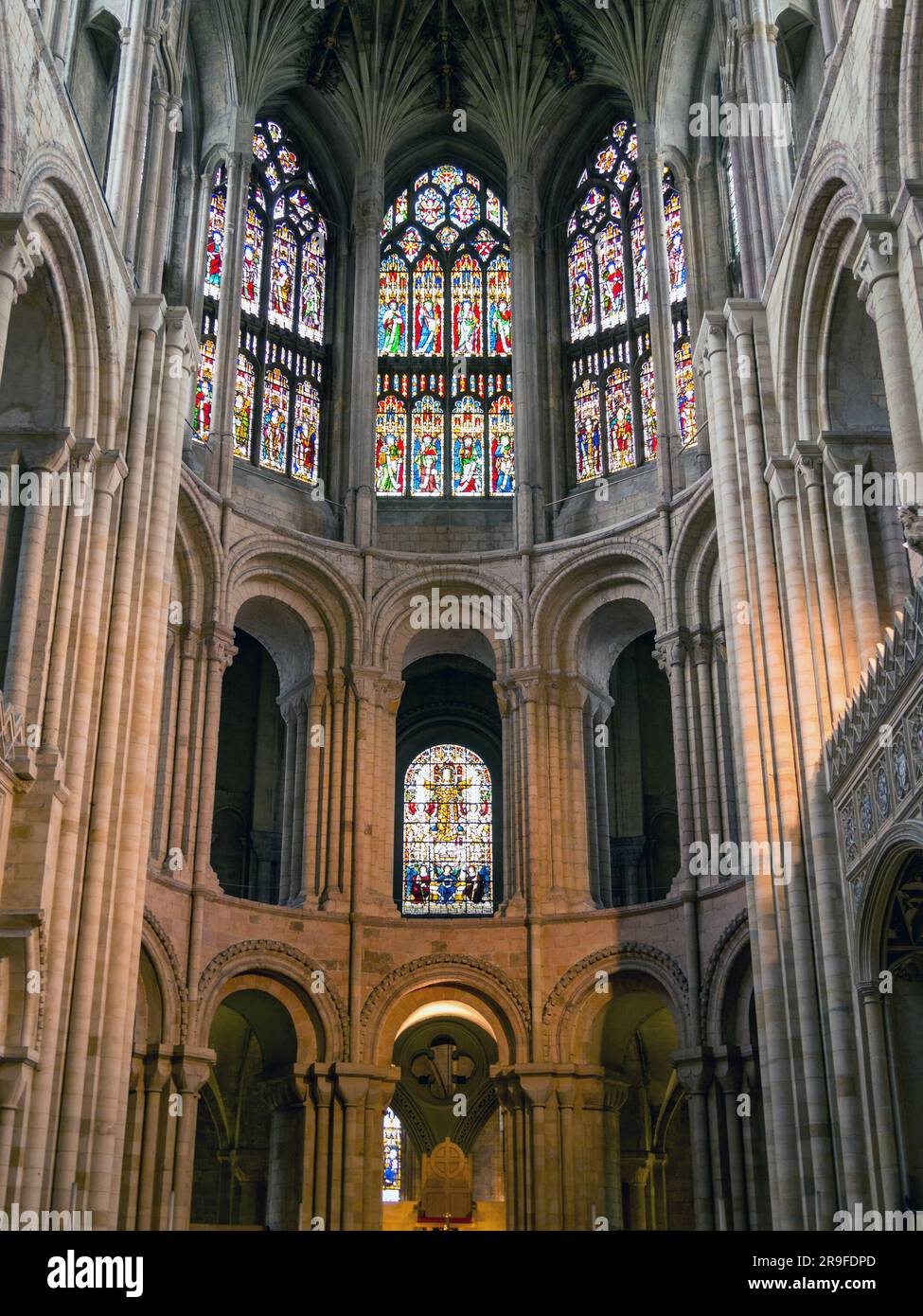 Arches, columns, pillars and stained glass windows of the Presbytery, Norwich Cathedral, Norwich, England, UK Stock Photo