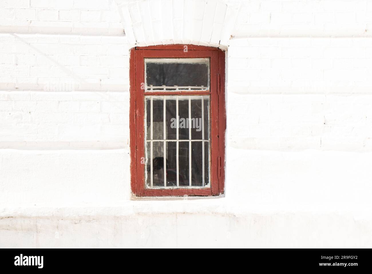 one window on a white wall in the sun, an old house Stock Photo - Alamy