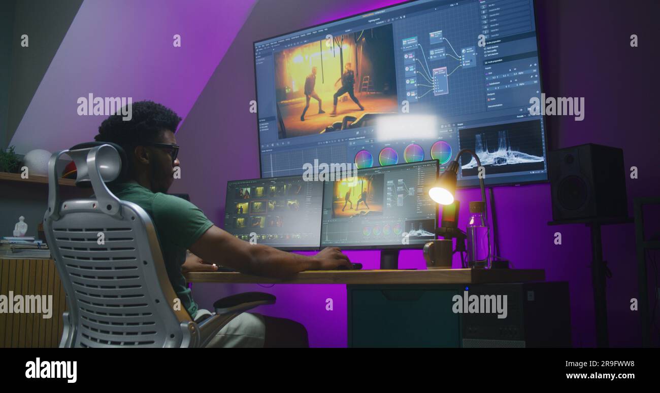 African American video editor makes color grading, works at home office ...