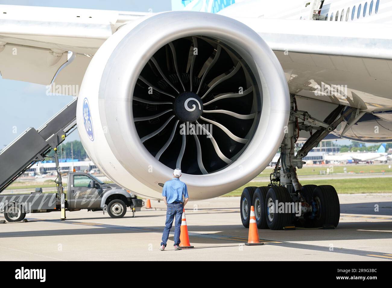 A Boeing employee gets a closer look at the engine on a Boeing 777-9, commercial jet that is in St. Louis for a layover at St. Louis-Lambert International Airport in St. Louis on Monday, June 26, 2023. The 777-9 is the only Boeing commercial airplane with St. Louis- made parts on the aircraft. Boeing employees will spend the day touring the aircraft, seeing it for the first time since production began. Boeing employees in St. Louis produce the 777-9's folding wing tip, moveable trailing edge and fixed leading edge on the wings, as well as the rudder and elevator on the empennage. Photo by Bill Stock Photo