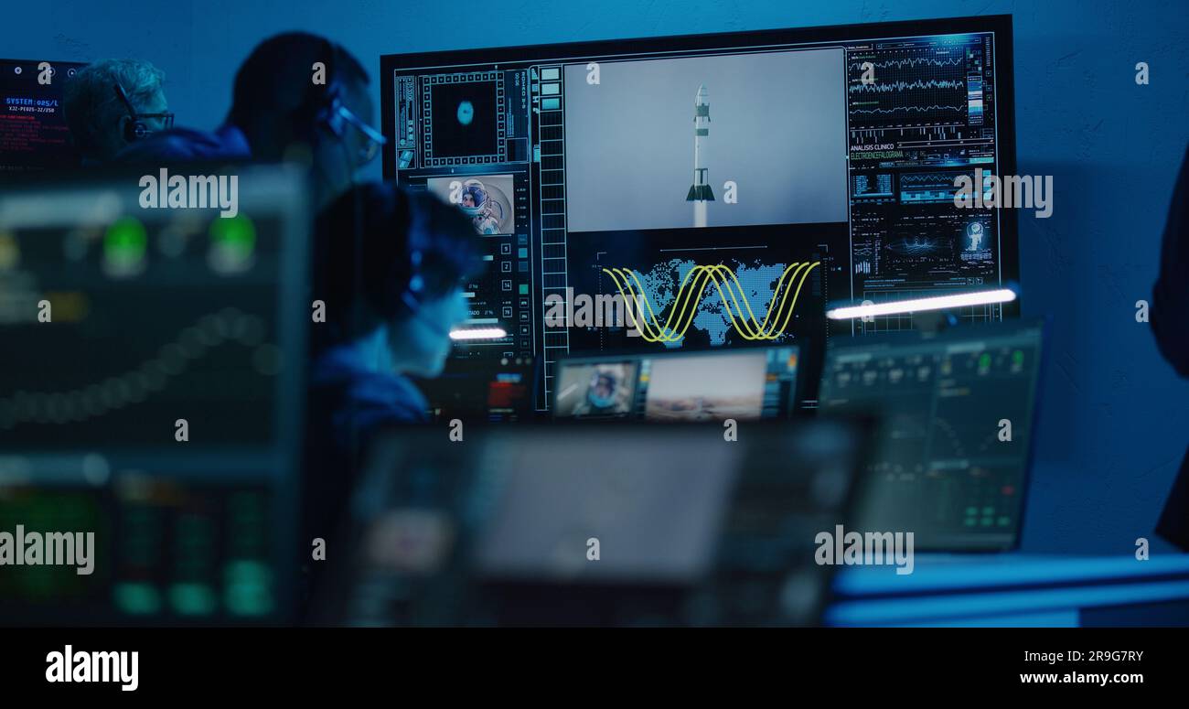 Flight control operators monitor space mission on computers in command ...