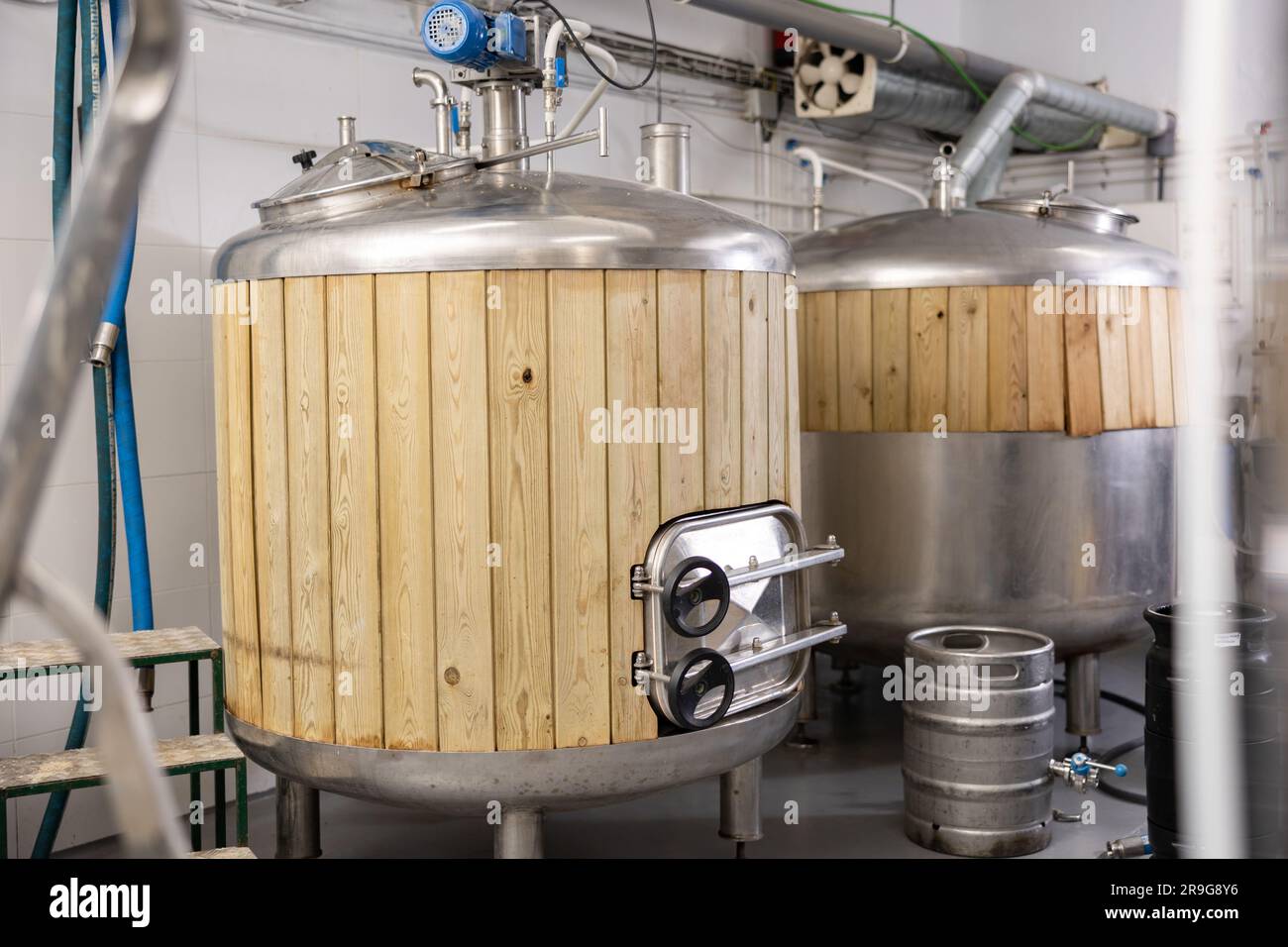 Beer tanks and barrels in brewery Stock Photo Alamy