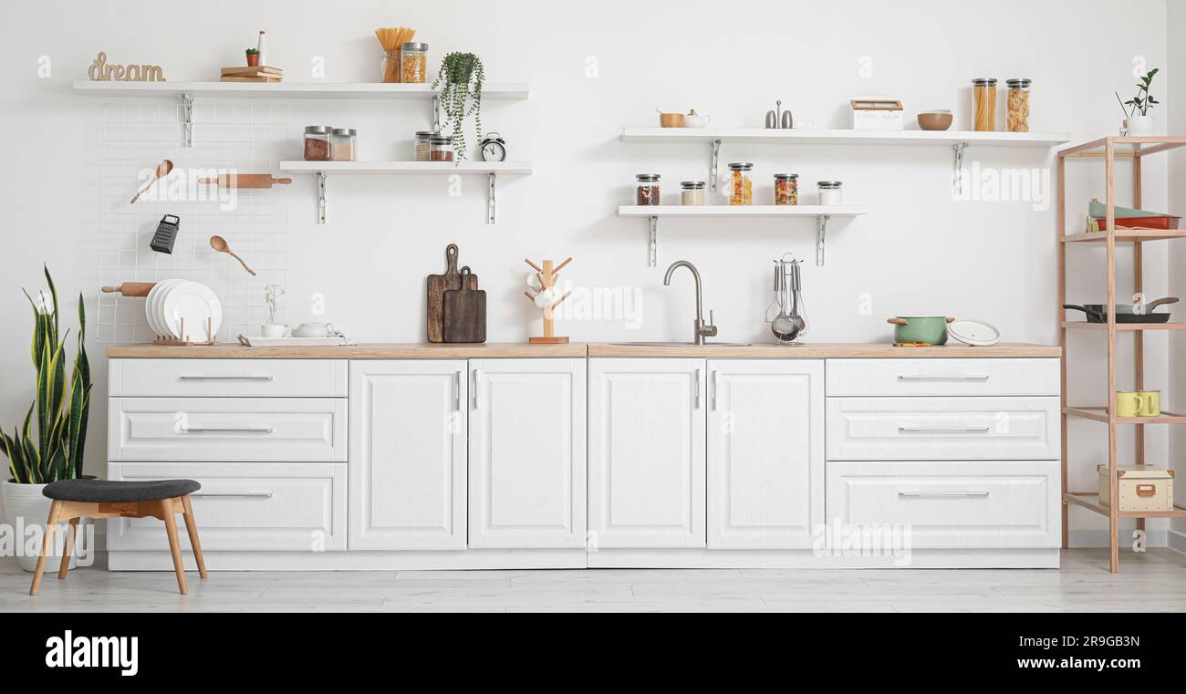 Interior of light kitchen with white counters and utensils Stock Photo ...