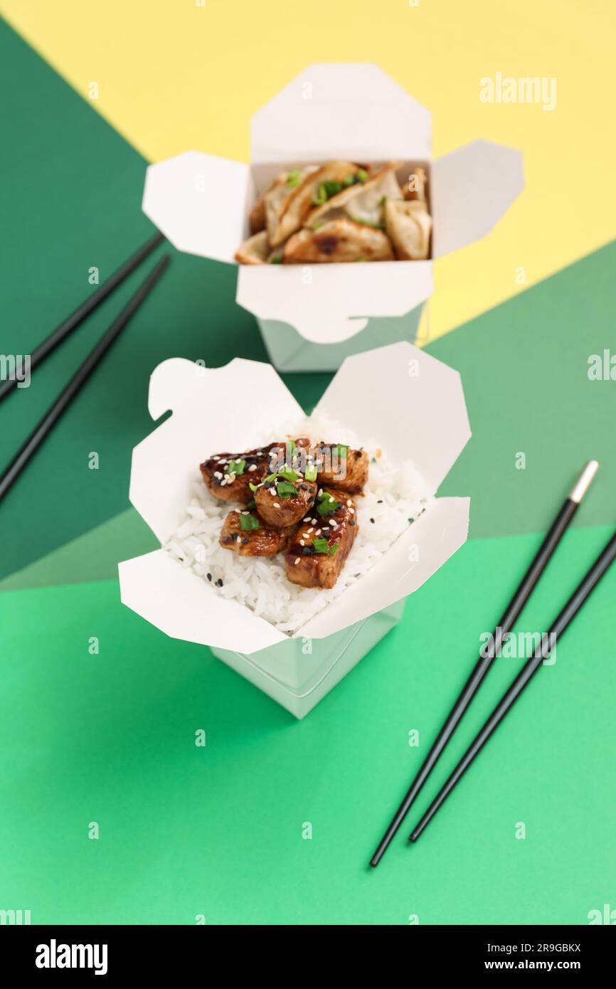 Boxes with tasty Chinese food and chopsticks on color background Stock  Photo - Alamy, image size:866x1390