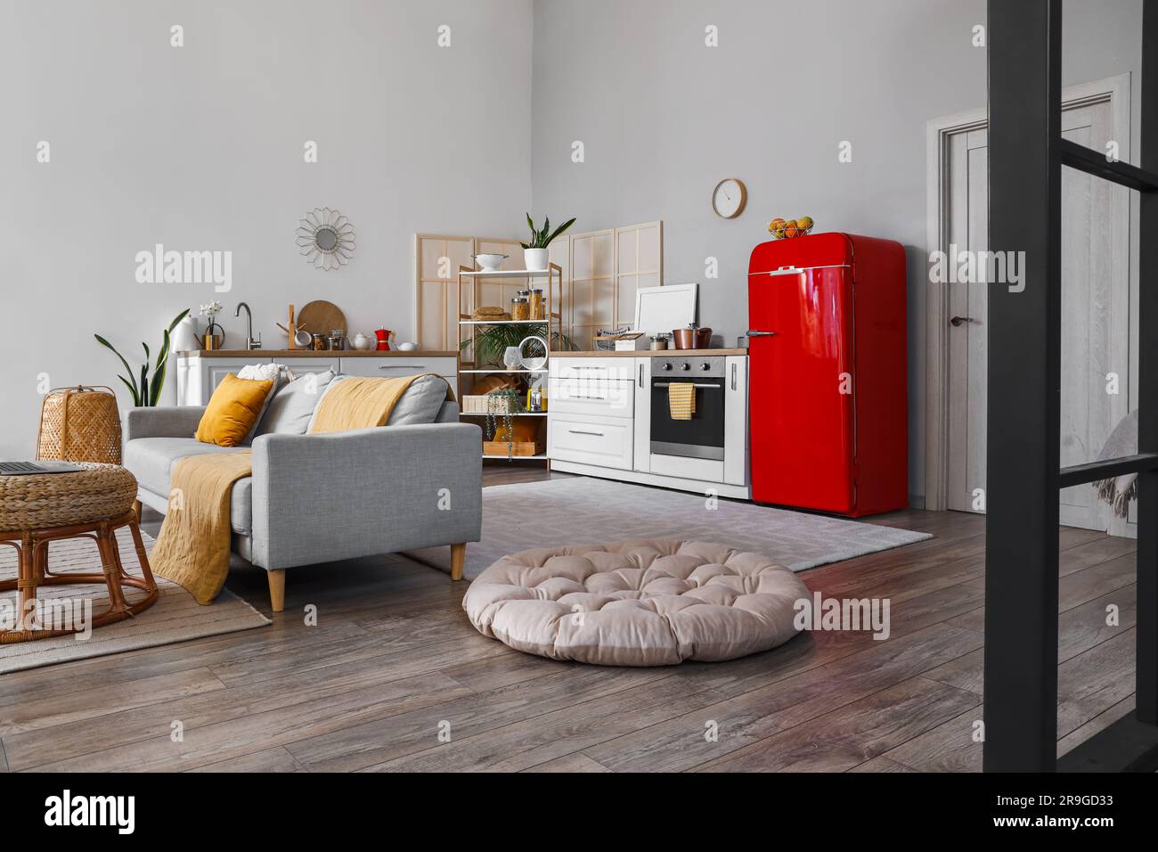 Interior of kitchen with red fridge, counters and sofa Stock Photo - Alamy