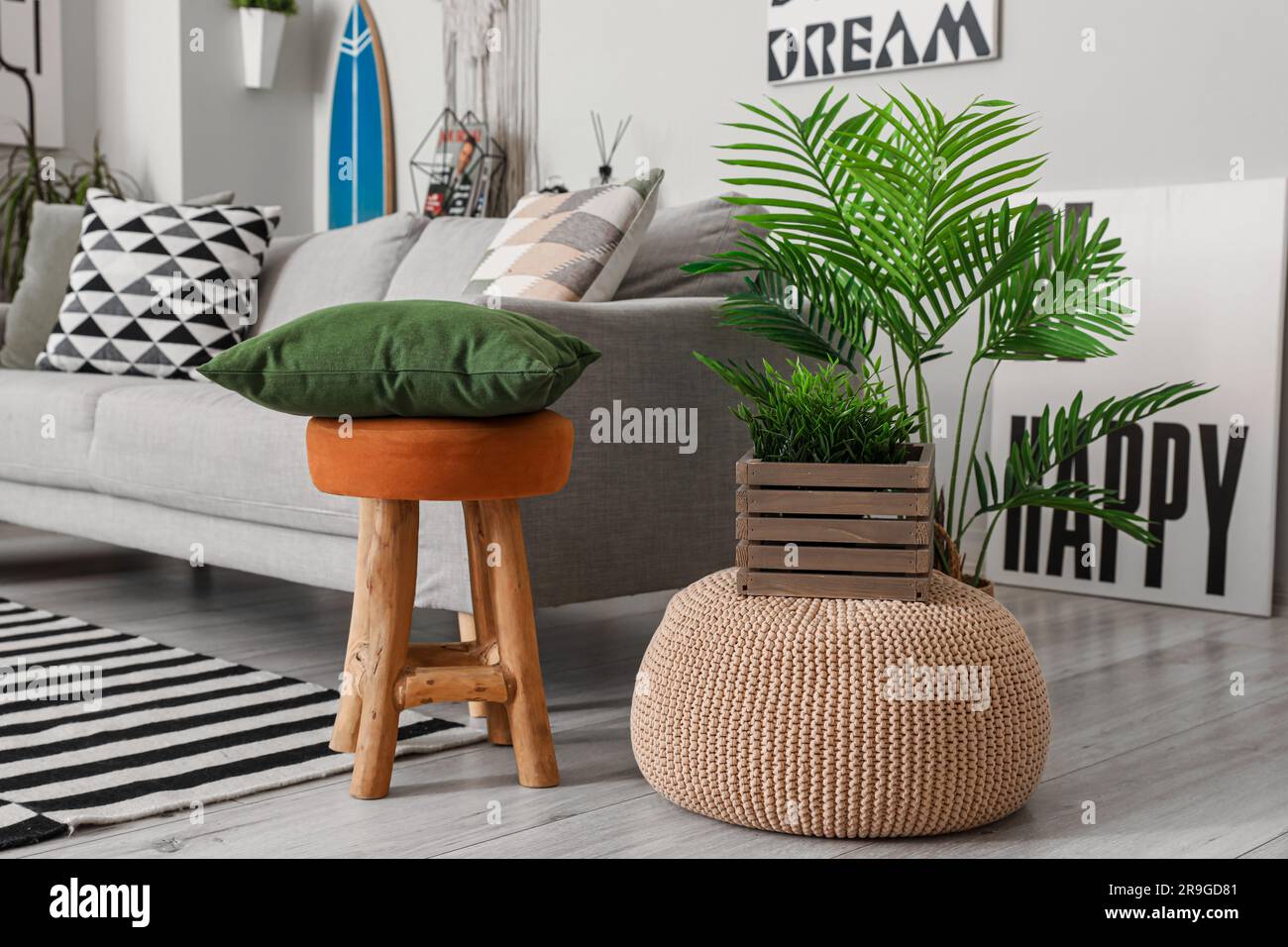 Interior of stylish living room with surfboard ottoman and sofa