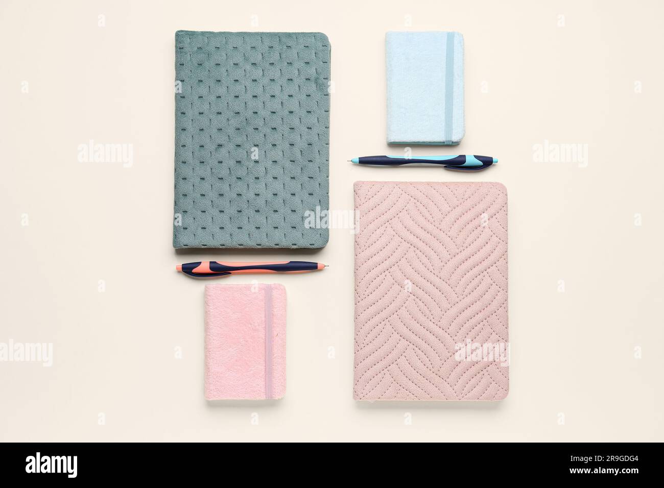 Composition with different notebooks and pens on light background Stock Photo