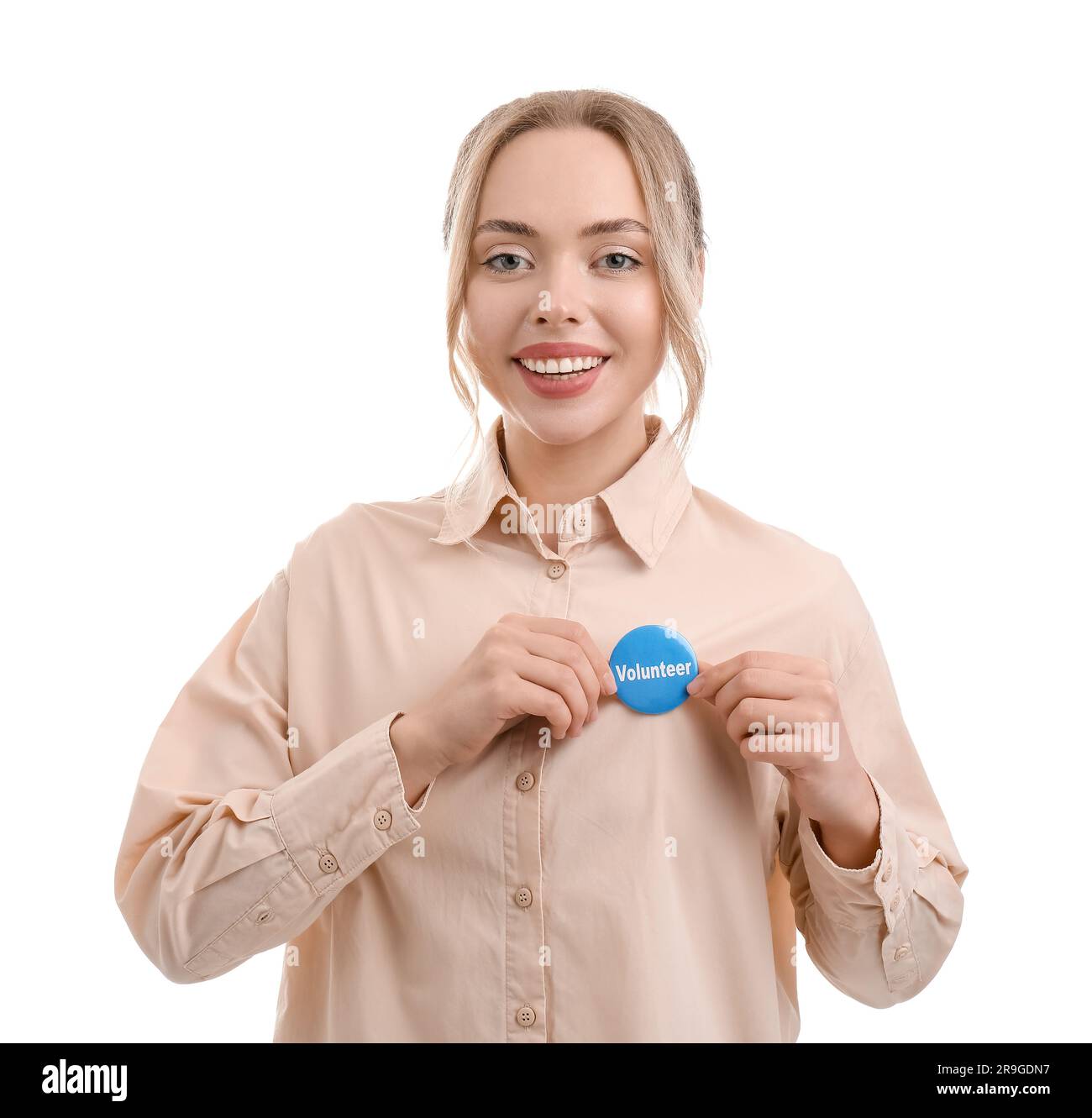 Female volunteer with badge on white background Stock Photo - Alamy
