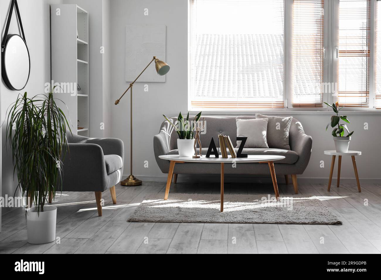 Interior of light living room with sofa, armchair and table Stock Photo ...