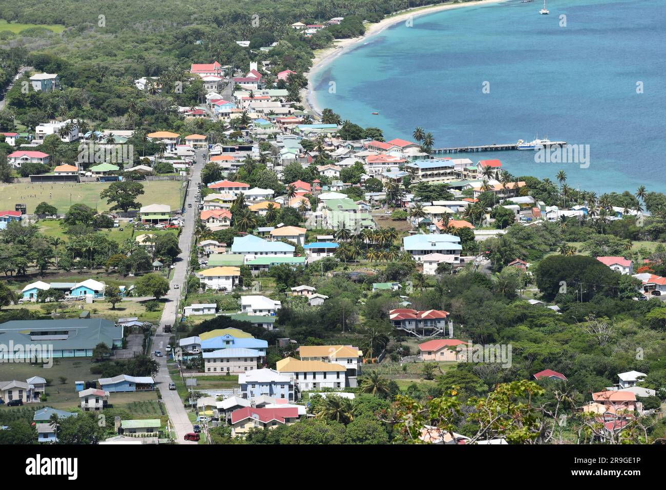 View from Belair, Carriacou, one of the islands off the coast of Grenada. In this photo the town of Hillsborough and the ocean can be seen. Stock Photo