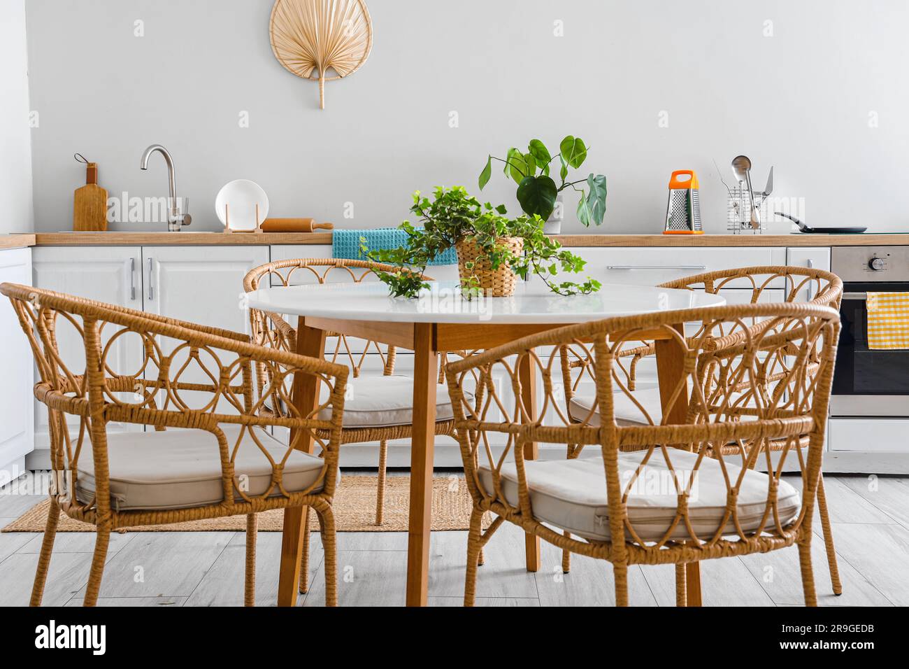 Interior of light kitchen with dining table and white counters Stock ...