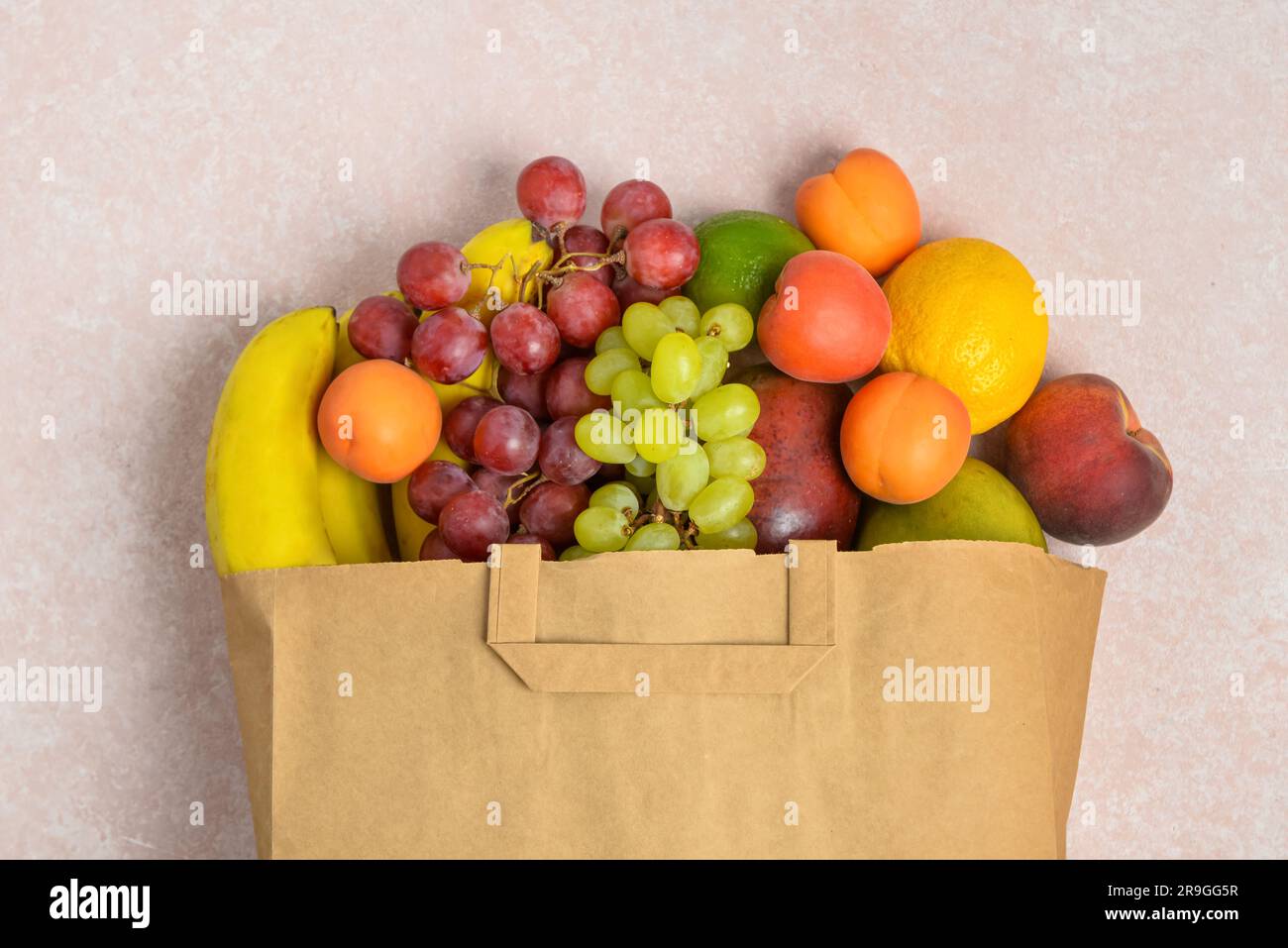 Paper bag with fresh fruits on grey background Stock Photo - Alamy
