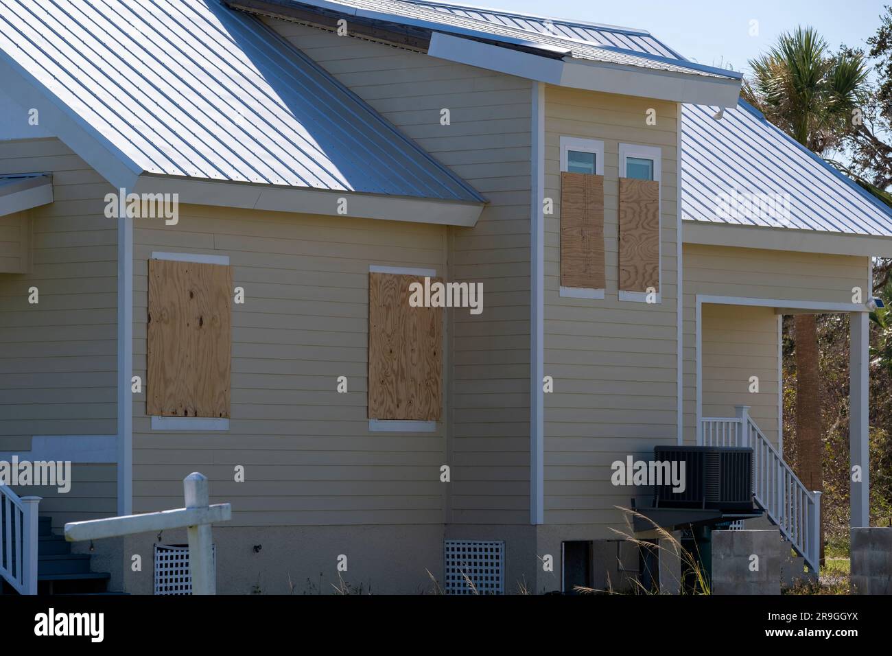 Hurricane shutters made from plywood mounted for protection of house