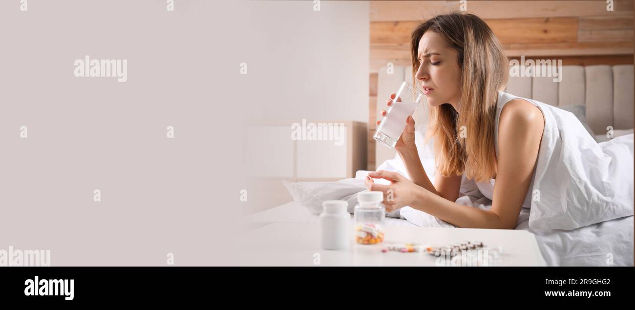 Woman taking medicine for hangover at home, space for text. Banner design Stock Photo