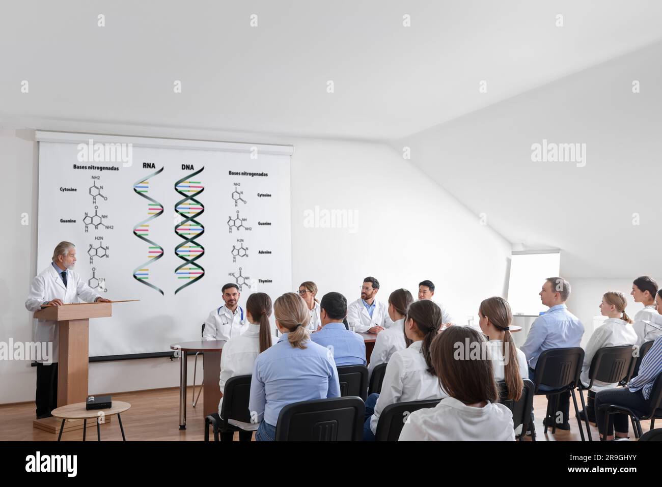 Lecture about difference between RNA and DNA. Professors and audience in conference room