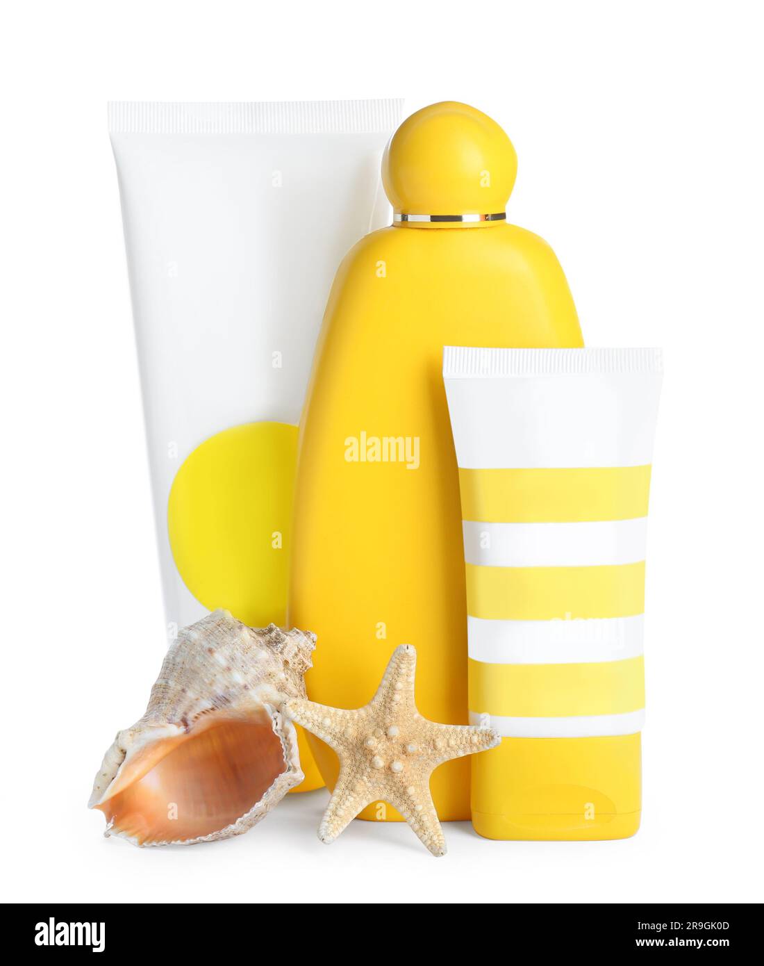 Different suntan products, starfish and seashell on white background