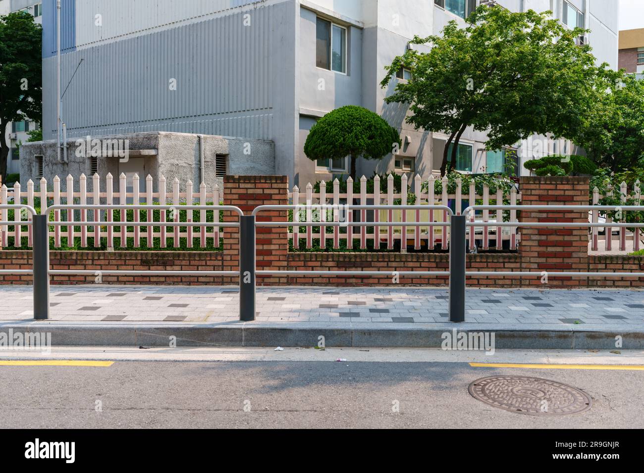road side view. Roads and sidewalks and apartment complexes separated by fences. A typical residential area in Seoul. Stock Photo