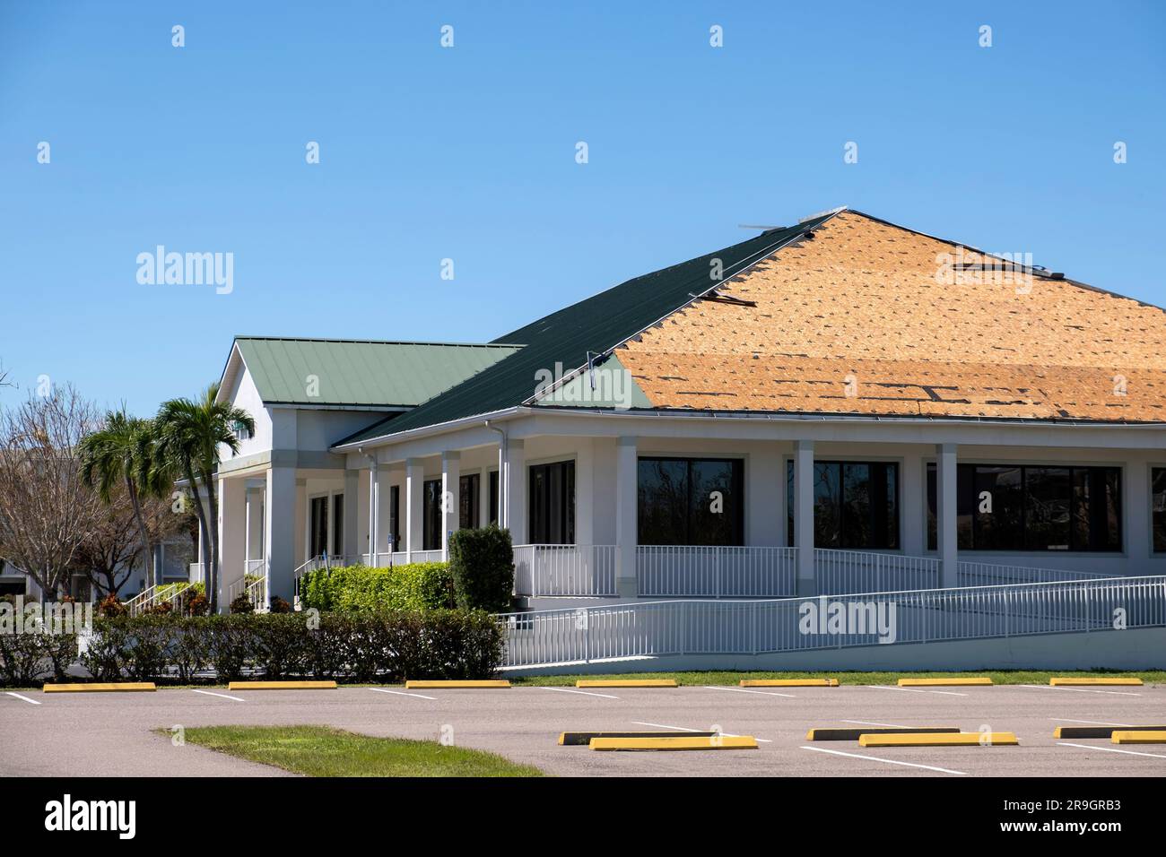 Ruined rooftop in need of repair. Wind damaged house roof with missing ...