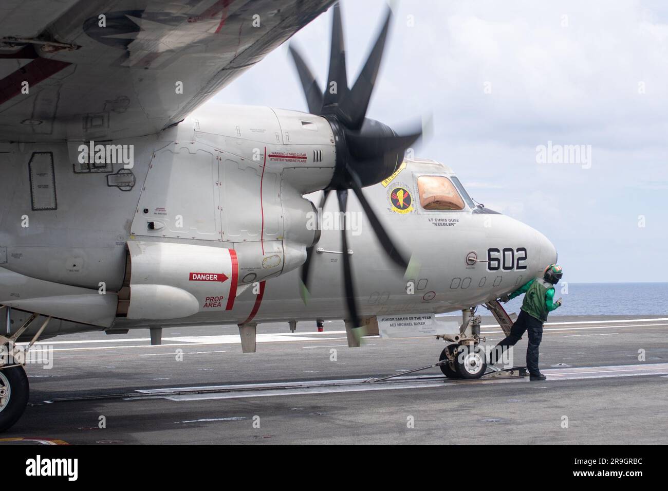 230622-N-YX844-1018 SOUTH CHINA SEA (June 22, 2023) Aviation Boatswain’s Mate (Aircraft Equipment) 3rd Class Shanastie Hublanco, from Naalehu, Hawaii, prepares an E-2D Hawkeye, attached to the Tiger Tails of Airborne Early Warning Squadron (VAW) 125, for takeoff aboard the flight deck of the U.S. Navy’s only forward-deployed aircraft carrier, USS Ronald Reagan (CVN 76), in the South China Sea, June 22, 2023. E-2D Hawkeyes perform tactical airborne, early warning missions to provide valuable information to Carrier Strike Group (CSG) 5 as it plans and executes operations. Ronald Reagan, the flag Stock Photo