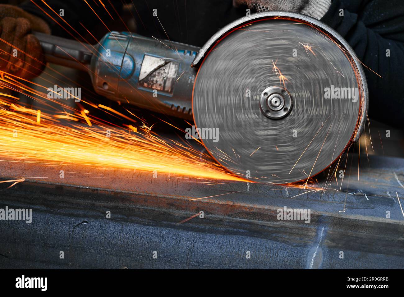 Cutting of metal beam with abrasive tool at metalwork plant Stock Photo