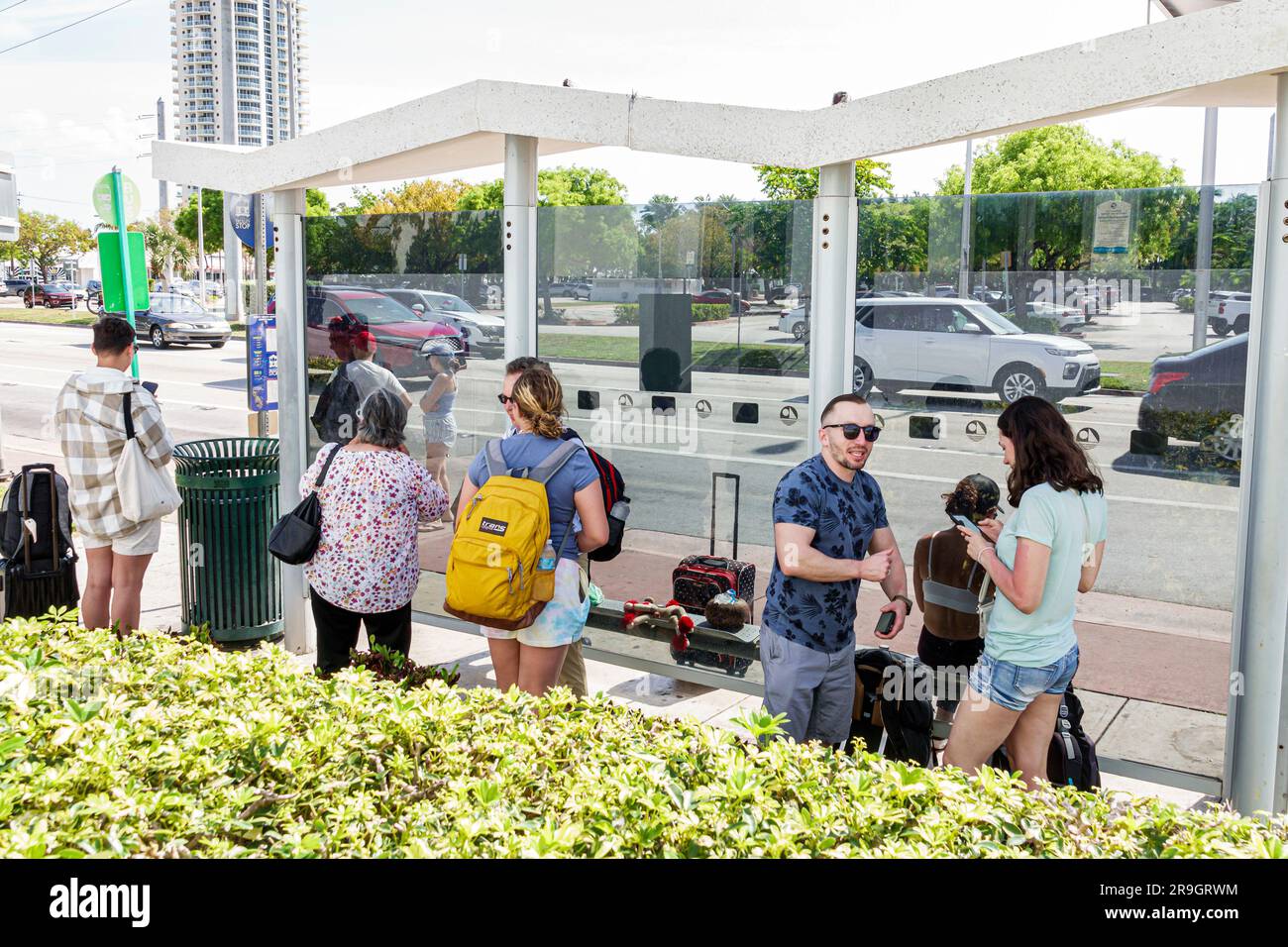 Miami Beach Florida,covered public bus stop riders passengers waiting ...