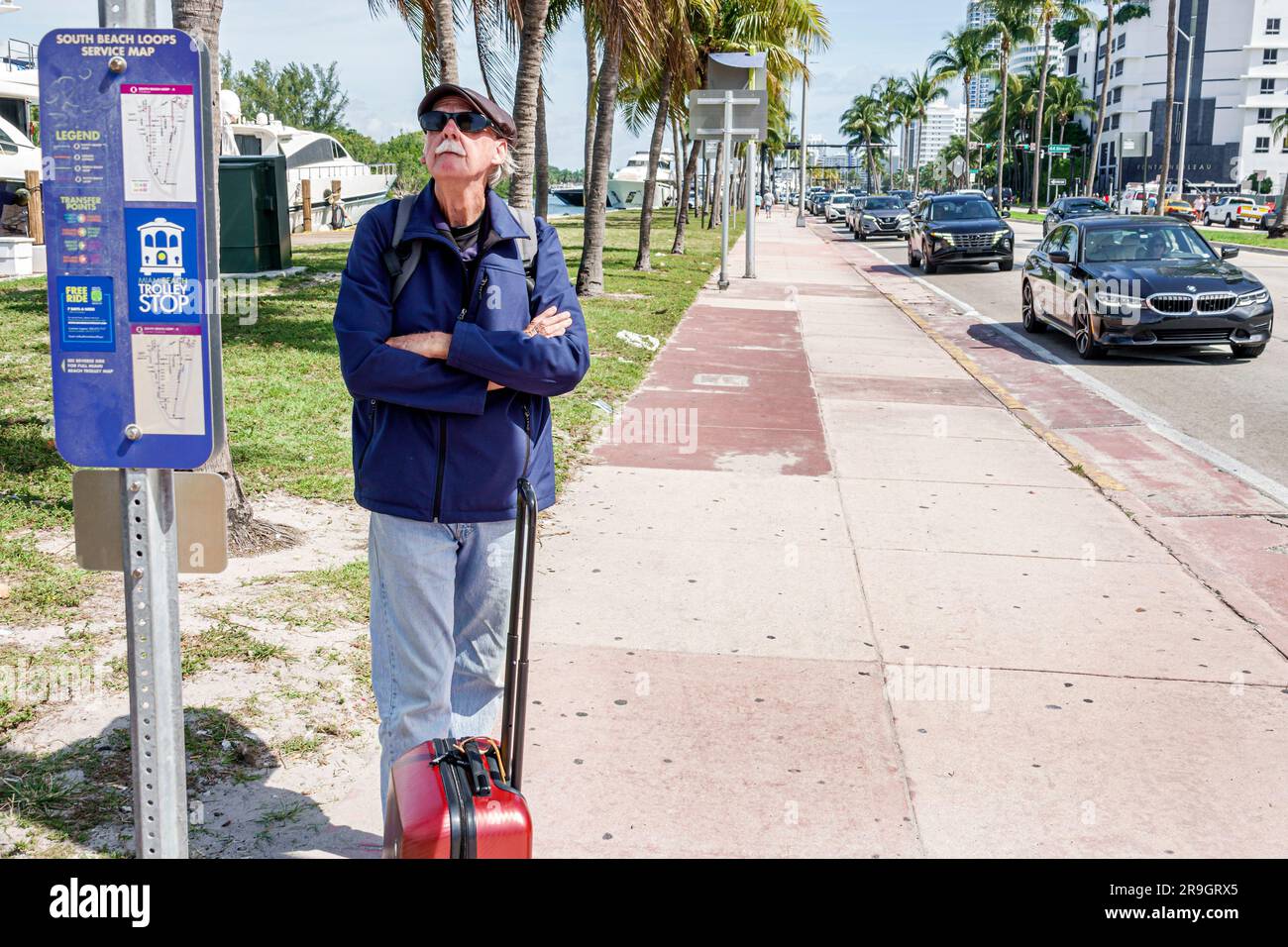 Miami Beach Florida,Miami-Dade Metrobus stop free trolley public transportation,senior man waiting passenger rider Stock Photo