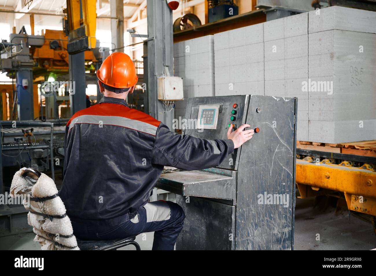 Worker presses buttons on equipment and controls process Stock Photo ...