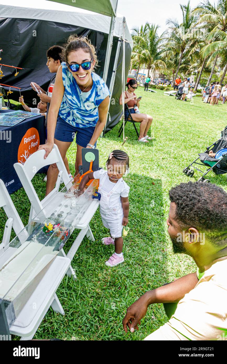 Miami Beach Florida,Altos del Mar Park,Turtle Fest festival event,family friendly,Black African American father man girl daughter reef rescue demonstr Stock Photo
