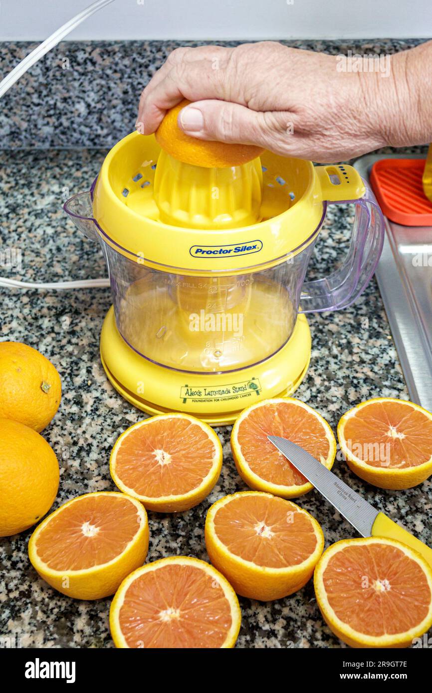 Miami Beach Florida,juicer electronic orange cut half halves making