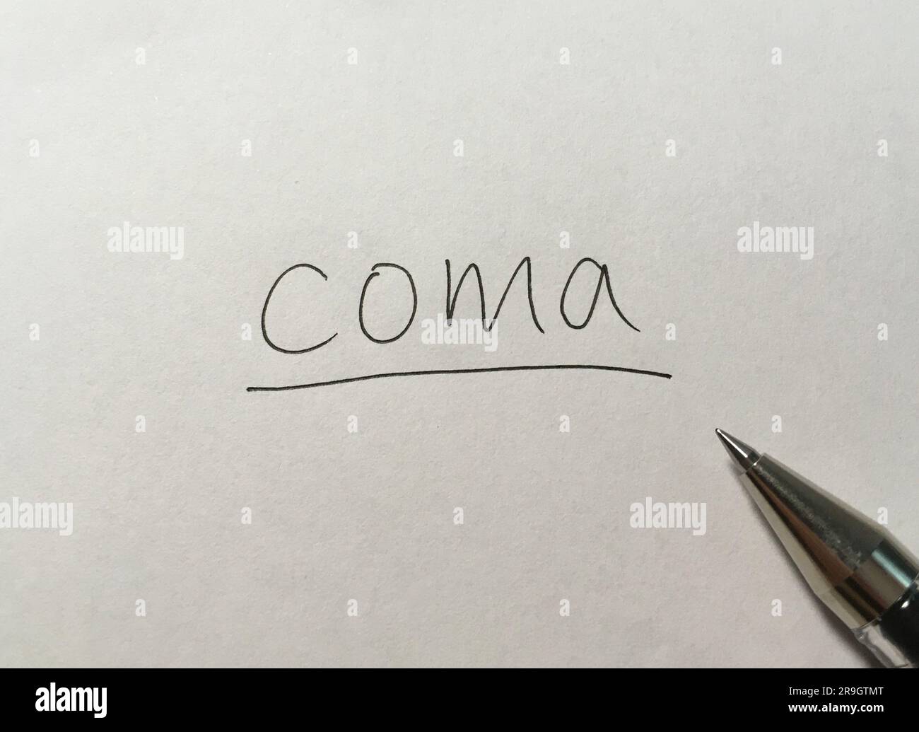 Coma concept word on paper background Stock Photo