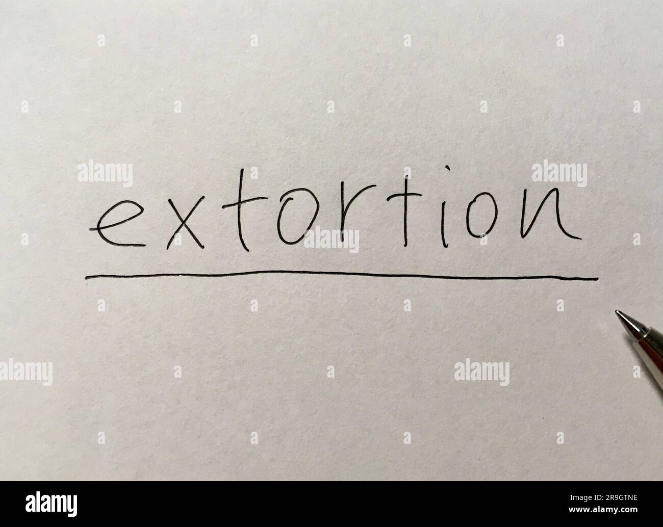 Extortion concept word on paper background Stock Photo