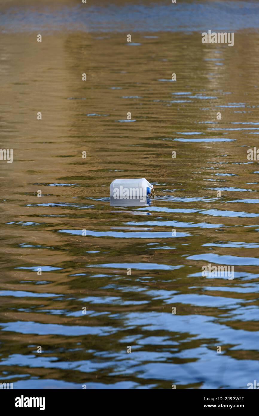 White plastic canister marking the fish trap floating on water