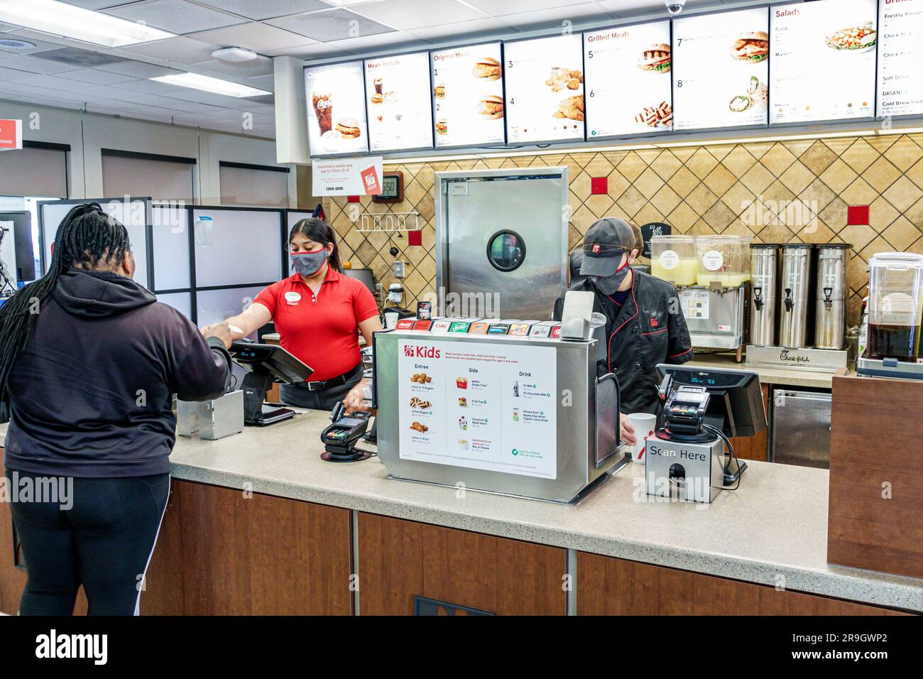 Macon Georgia,Chick-fil-A fast food restaurant,inside counter women employees customer,inside interior indoors Stock Photo