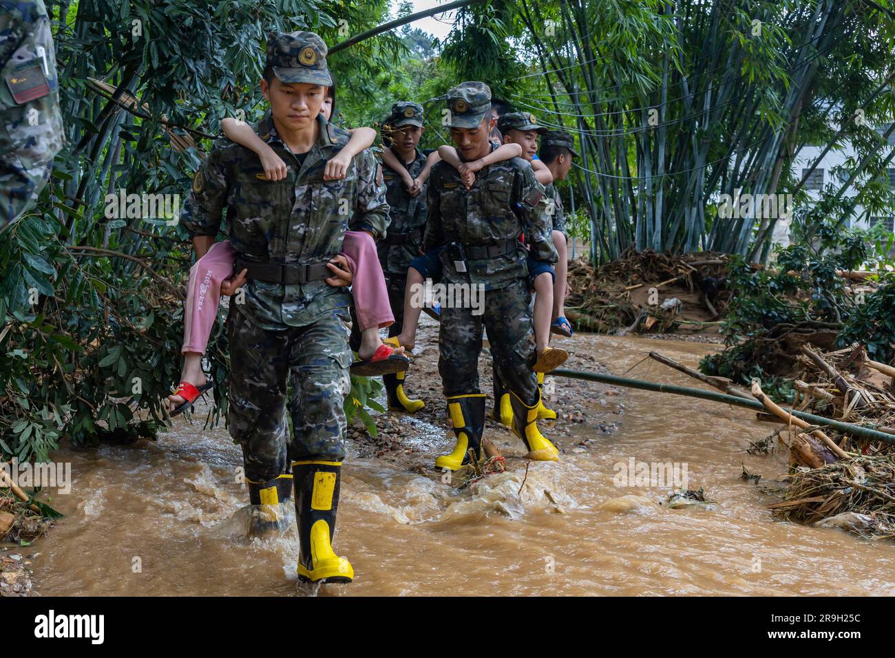 YULIN, CHINA - JUNE 26, 2023 - Armed police officers move flood victims in Yulin city, South China's Guangxi Zhuang Autonomous region, June 26, 2023. Stock Photo