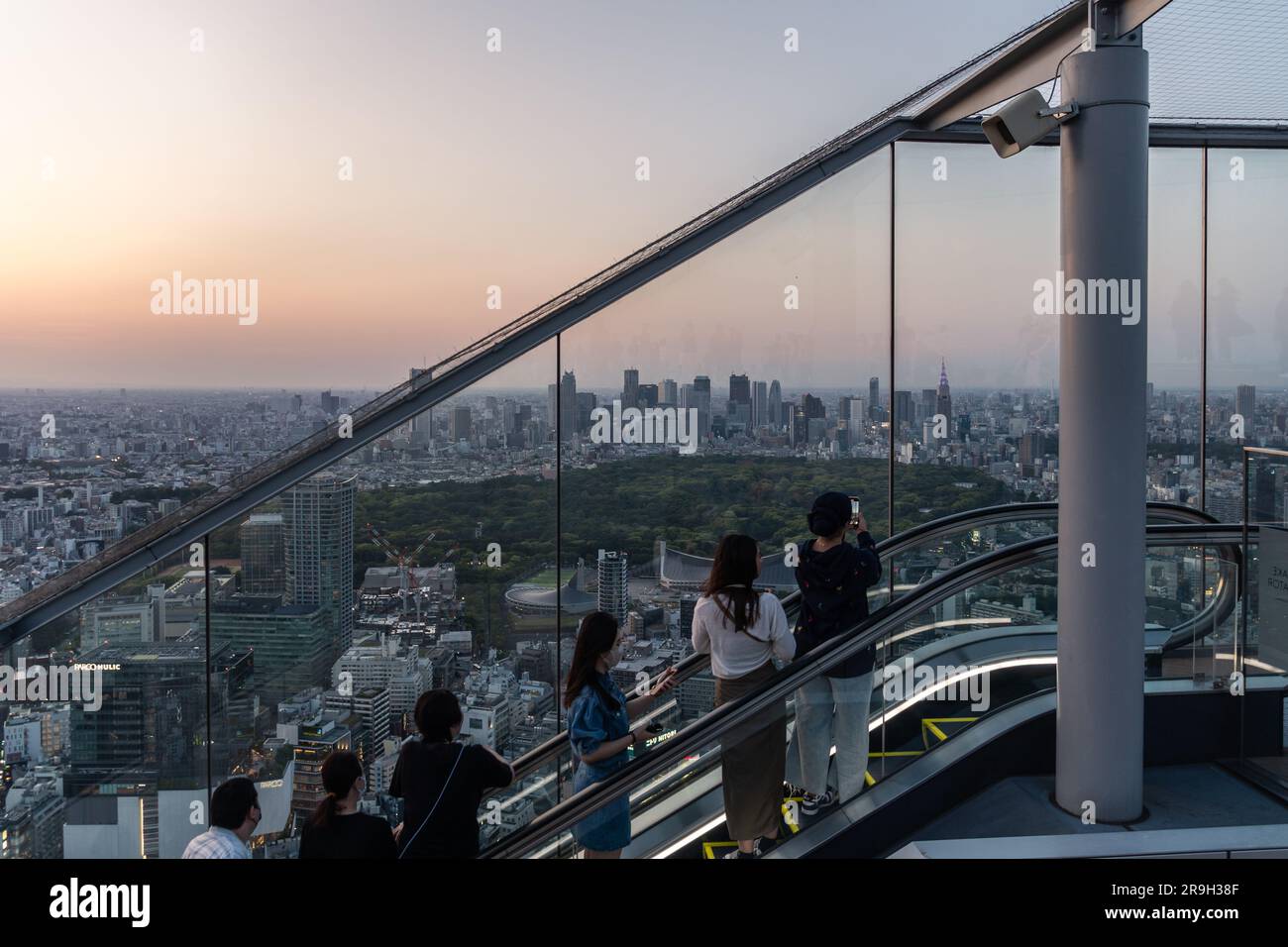 Tokyo, Japan - May 04 2023: People take photo while riding the escalator up the Shibuya Sky observation desk in Japan capital city at sunset Stock Photo