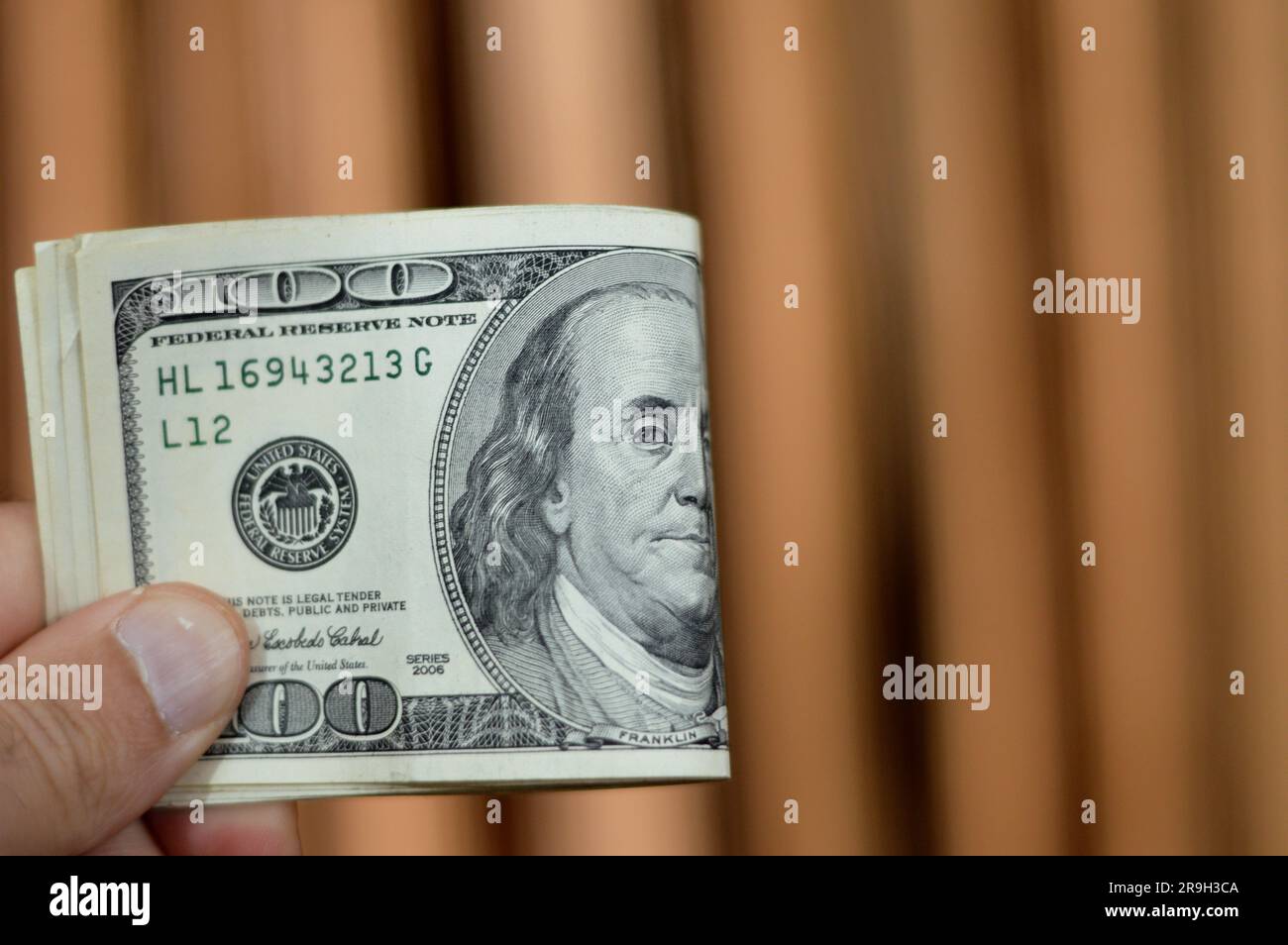 Folded 100 one hundred dollar banknote currency cash money old series with the portrait of president Benjamin Franklin on obverse and independence hal Stock Photo