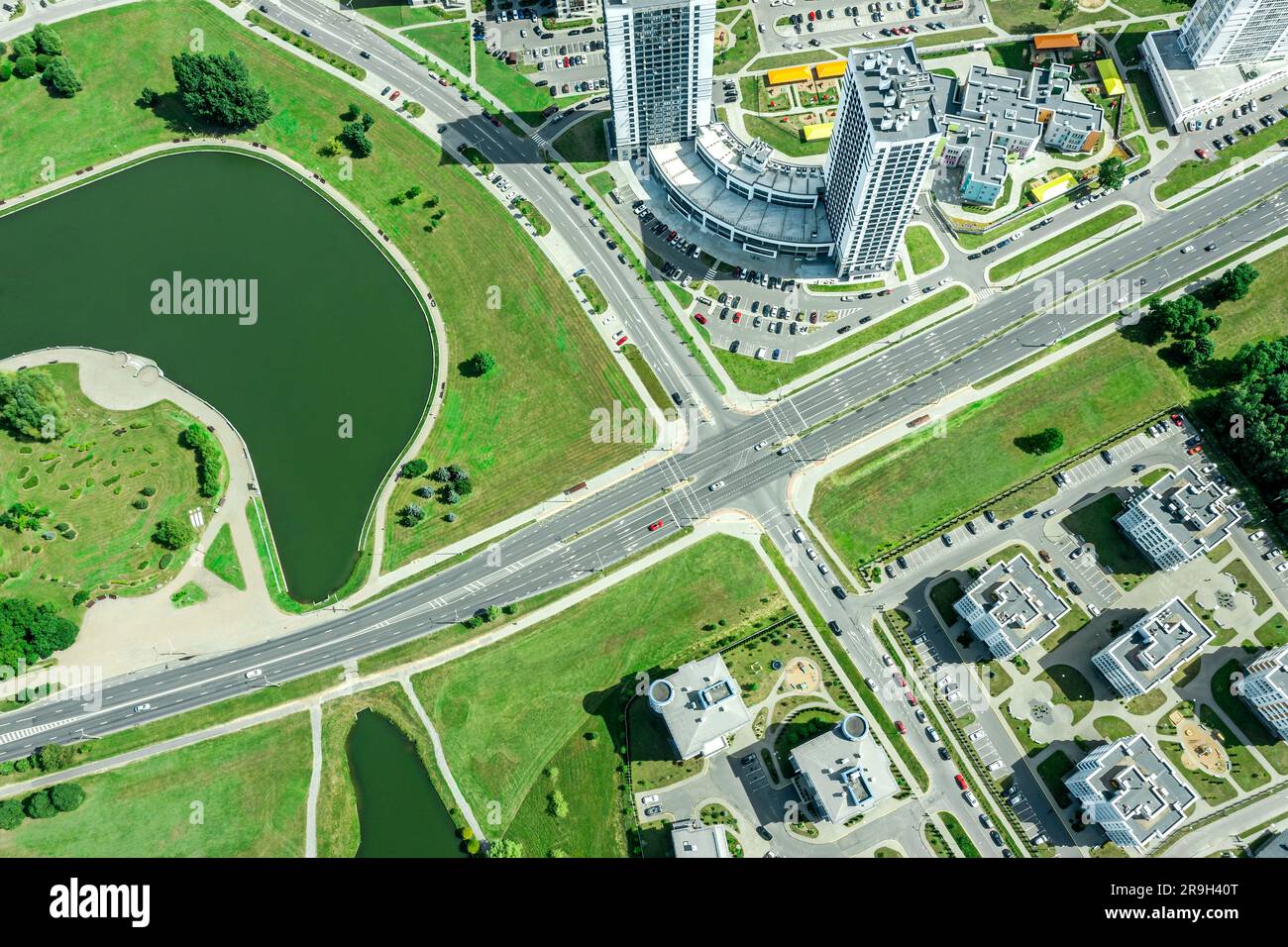 roads intersection in residential area. aerial top view of urban crossroad in sunny summer day. Stock Photo