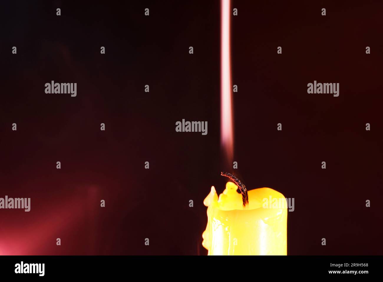 candle with smoke and flame photographed in the studio with color foils