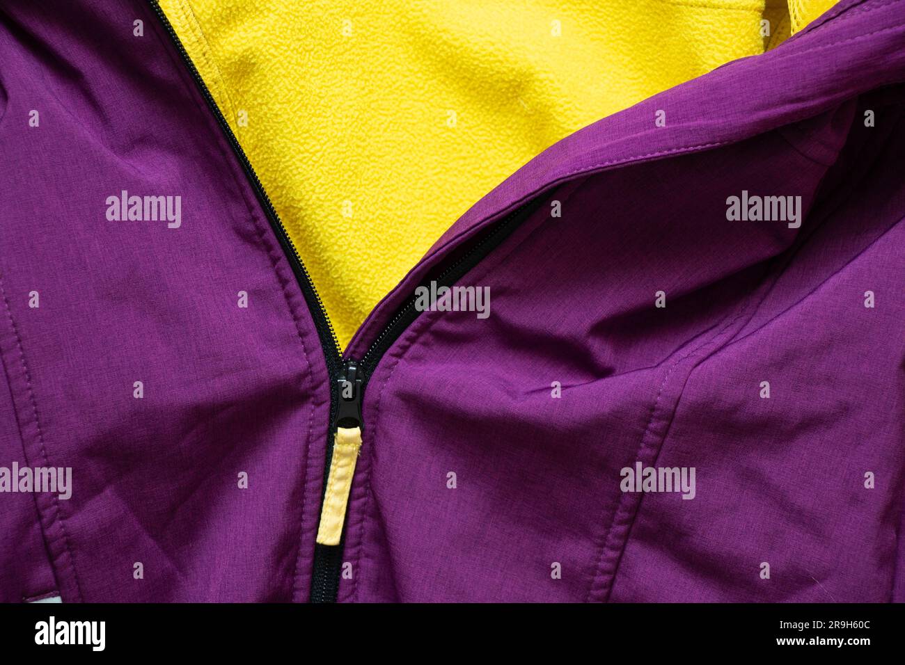 zipper on purple jacket as background close up Stock Photo