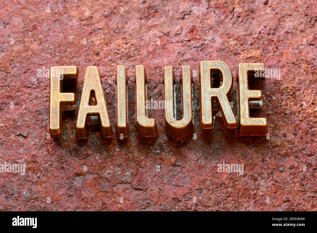 failure word made from metallic letters on red rusty surface Stock Photo