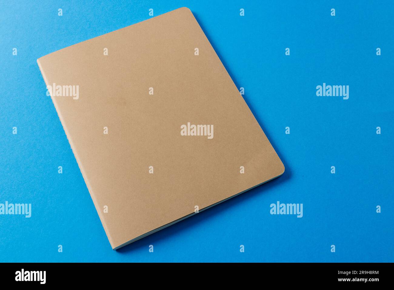 Close up of beige notebook with copy space on blue background Stock ...