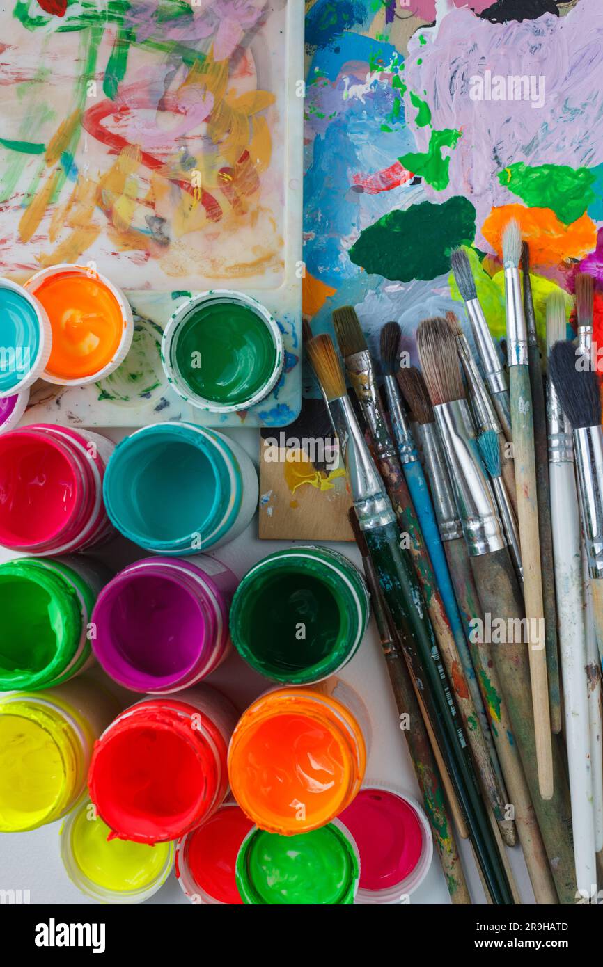 Paint palette with various acrylic paints and a brush Stock Photo