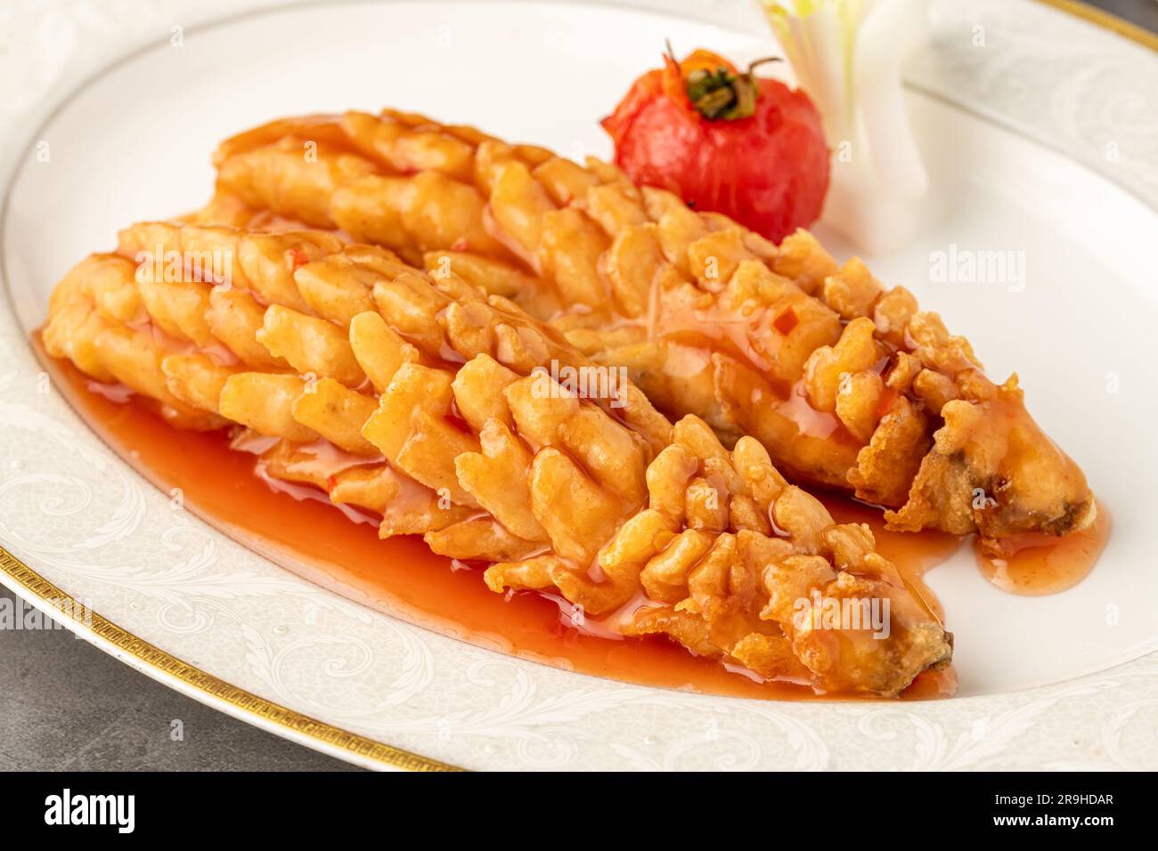 Squirrel fish on a white porcelain plate in a fine dining restaurant Stock Photo