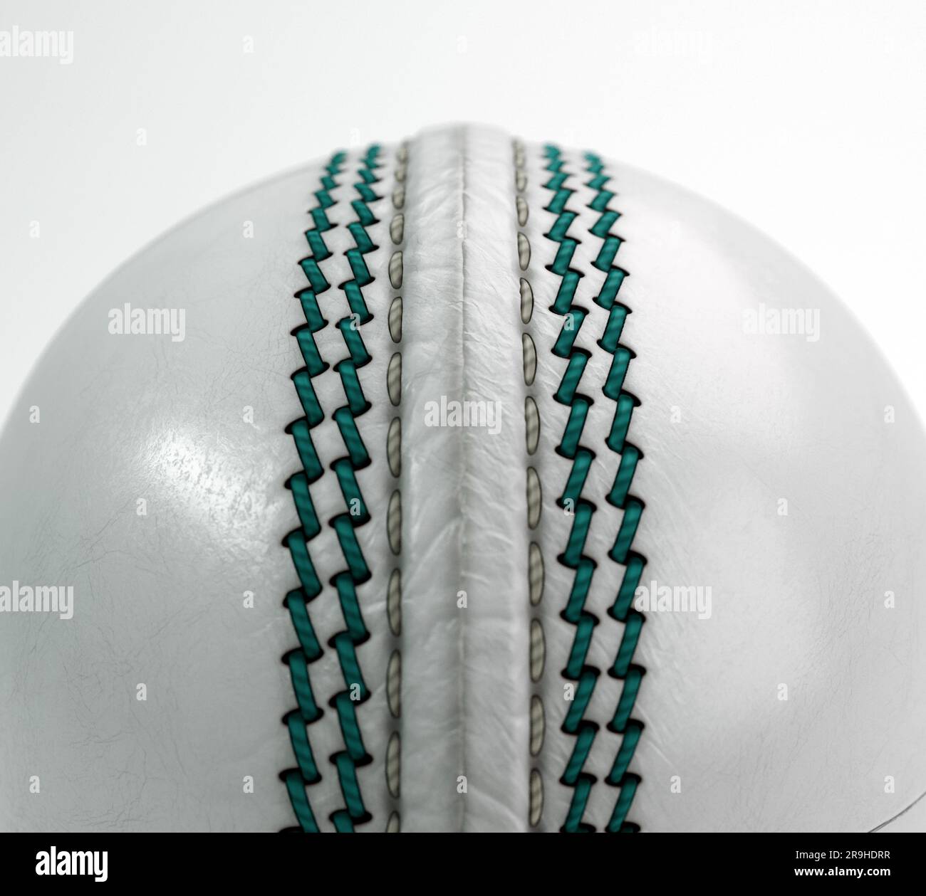 A regular white cricket ball with green stitching on an isolated