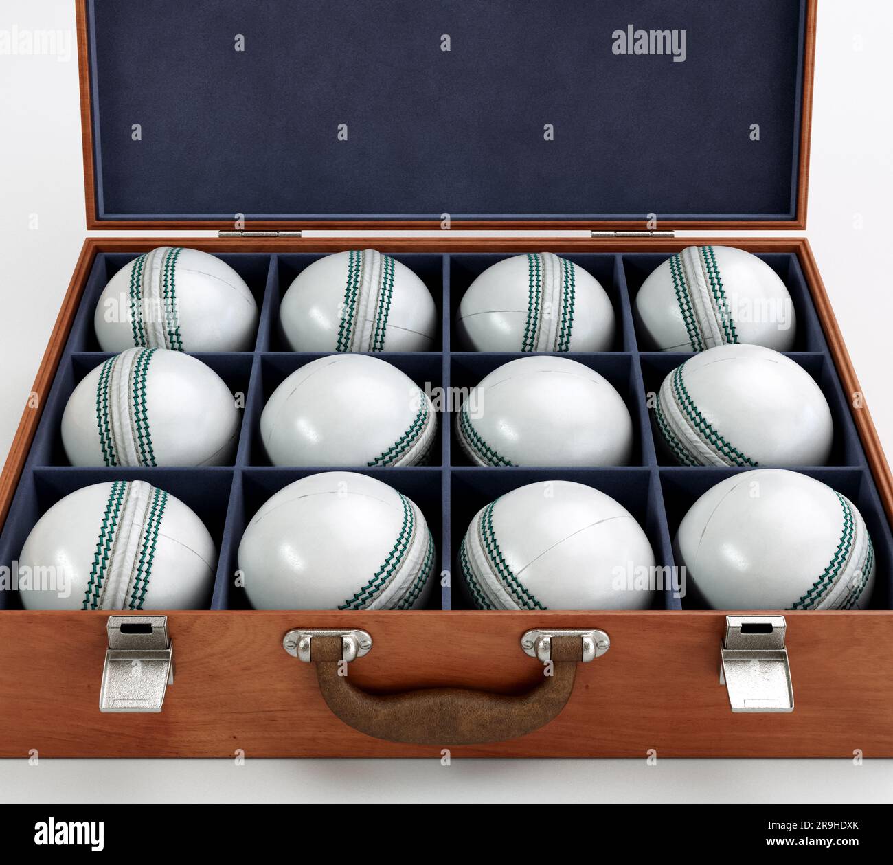 Twelve generic white cricket balls in a wooden display box lined with felt on an isolated white background - 3D render Stock Photo